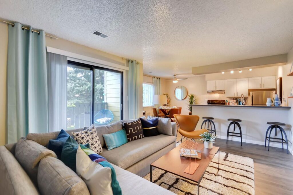 Living room and kitchen area at Park Place at 92nd Apartments for rent in Westminster, CO
