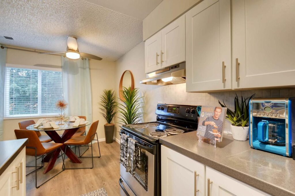 Modern kitchen with white cabinets at Park Place at 92nd Apartments in Westminster, CO