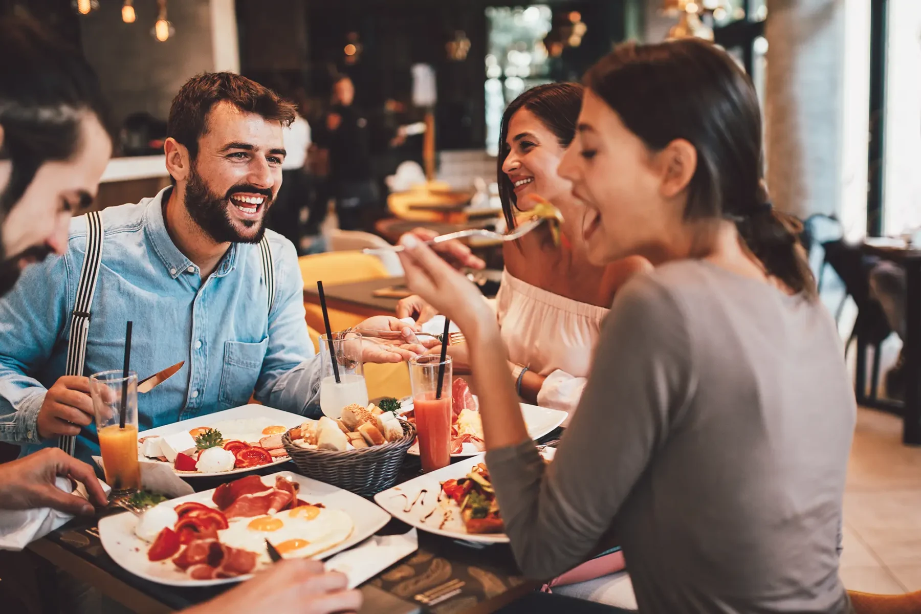 Friends at a restaurant eating and laughing together