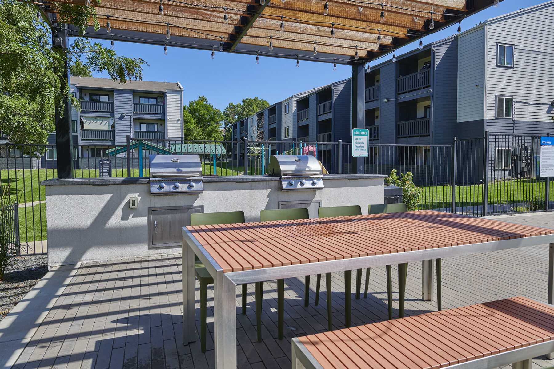 Outdoor grilling stations with dining area at Park Place at 92nd affordable apartments in Westminster, CO
