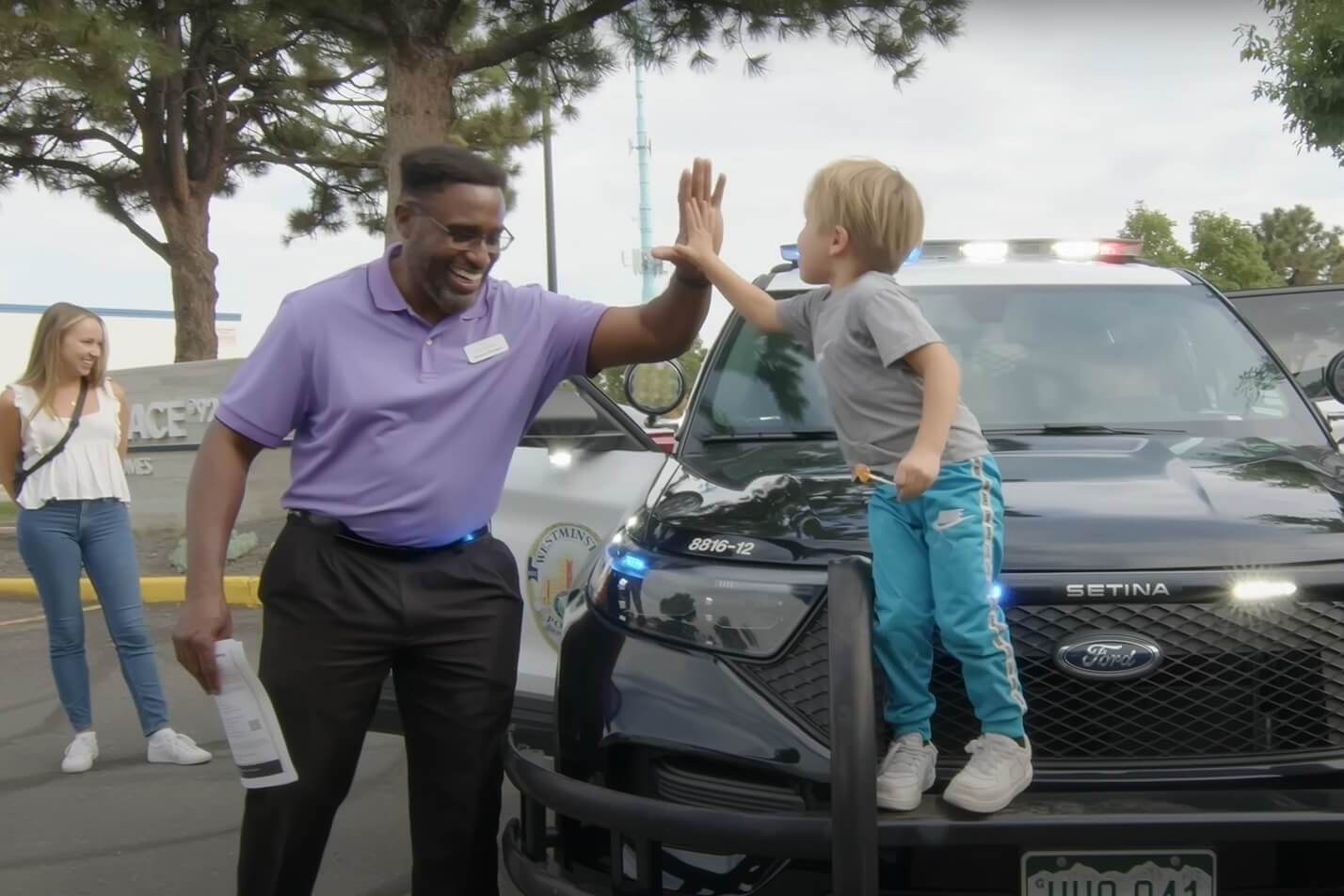 Man and child giving high five and smiling on sunny day outside